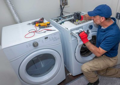 Serviceman repairing a laundry machine