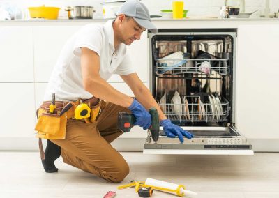 serviceman repairing a washing machine